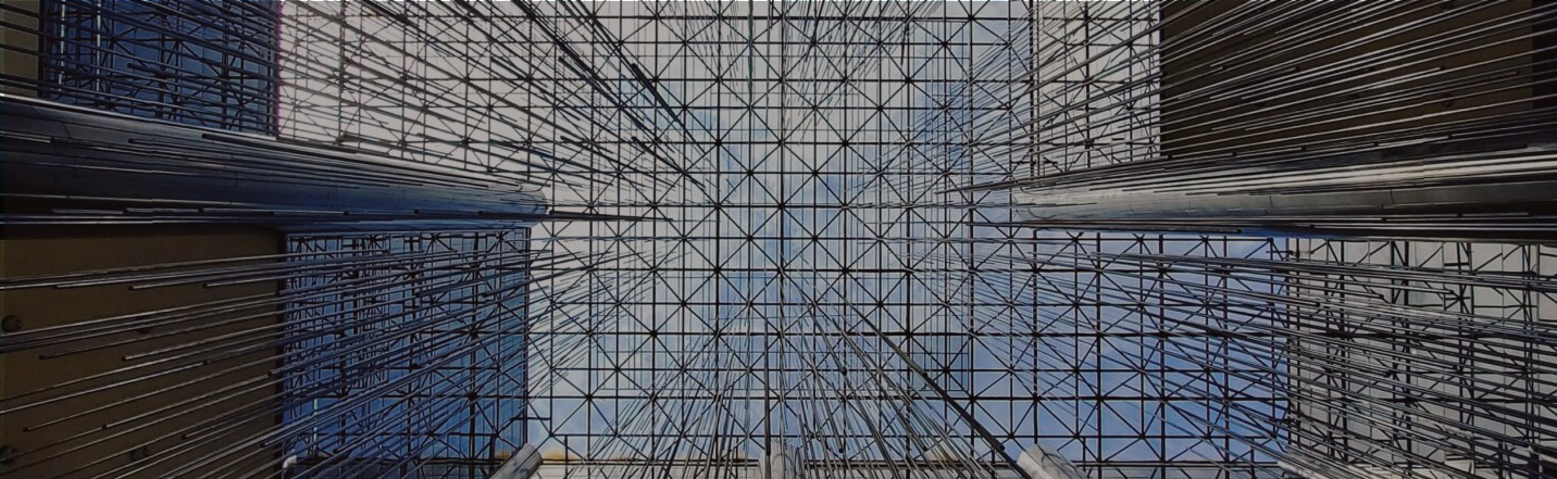 Graphic photograph of glass ceiling with many metal bars insersecting in a futuristic style